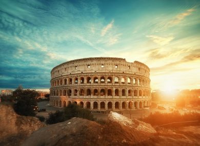 A beautiful shot of the famous Roman Colosseum amphitheater under the breathtaking sky at sunrise